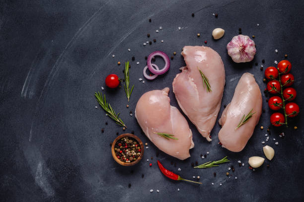 istock Raw chicken fillet with spices and herbs 1285310706