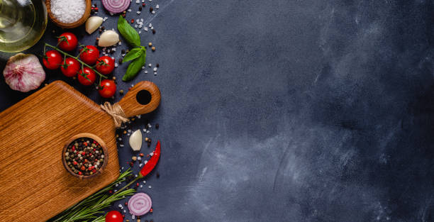 istock Herbs and condiments on black stone background. 1285310776