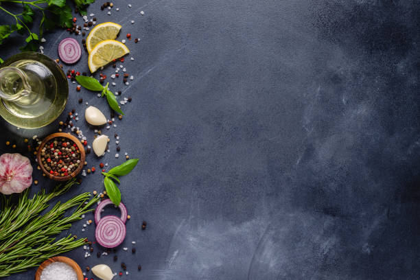 istock Herbs and condiments on black stone background. 1285311506