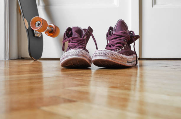 Used canvas shoes on wooden floor