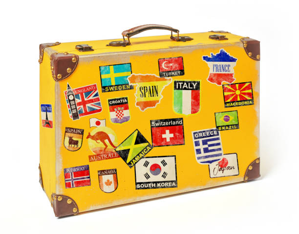 istock Yellow luggage with country stickers 1285312454