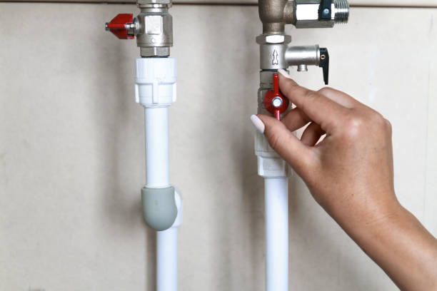 istock Woman's hand closes the valve. Saving Water Consumption Concept 1285313123