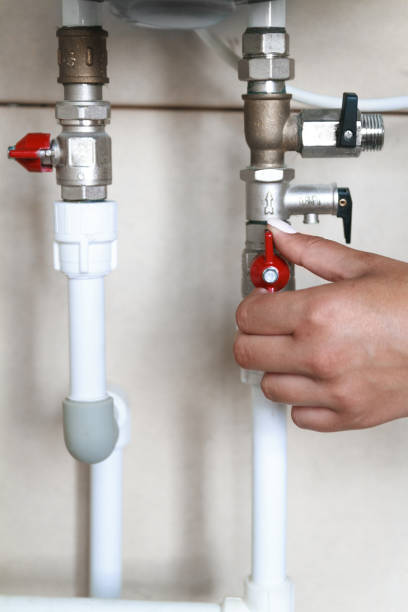 istock Woman's hand closes the valve. Saving Water Consumption Concept 1285313147
