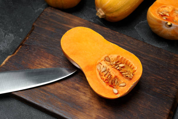 istock Raw orange pumpkin and wooden cutting board 1285313544