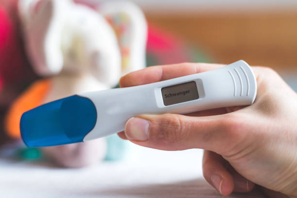 istock Woman checking pregnancy test. Result positive, “Schwanger” 1285313587