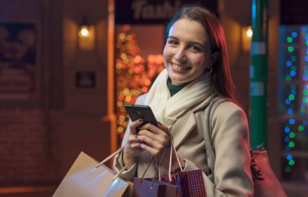 istock Happy woman doing Christmas shopping and using her smartphone 1285313661