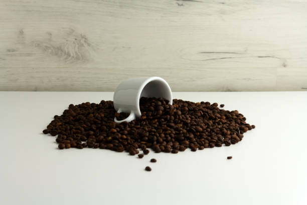 istock A cup is lying on a pile of coffee beans. Light background, horizontal orientation 1285313666
