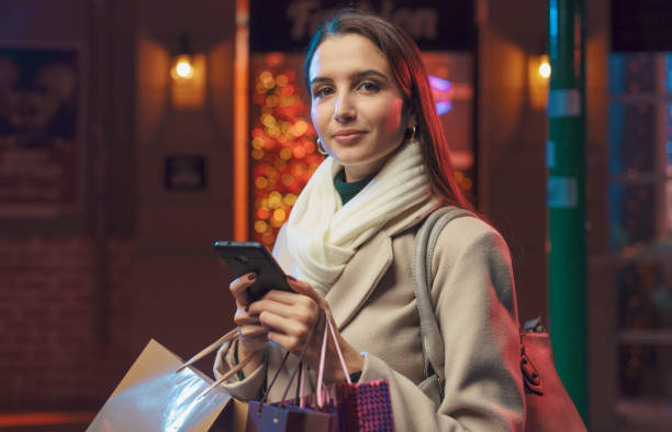 istock Happy woman doing Christmas shopping and using her smartphone 1285313977