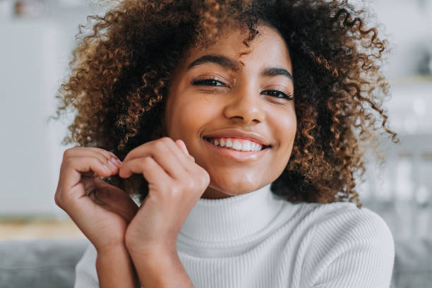 istock Young African model holds hands in heart shape near face 1285315208