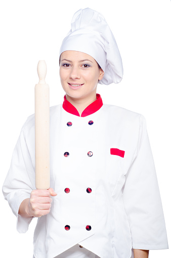 Female chef holding rolling pin isolated against white background.