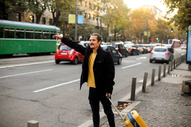 istock Man stopping a taxi 1285316345