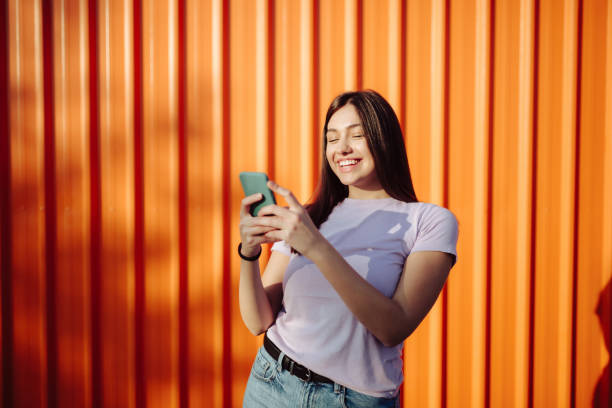 istock Happy young Caucasian woman using a smart phone 1285316464