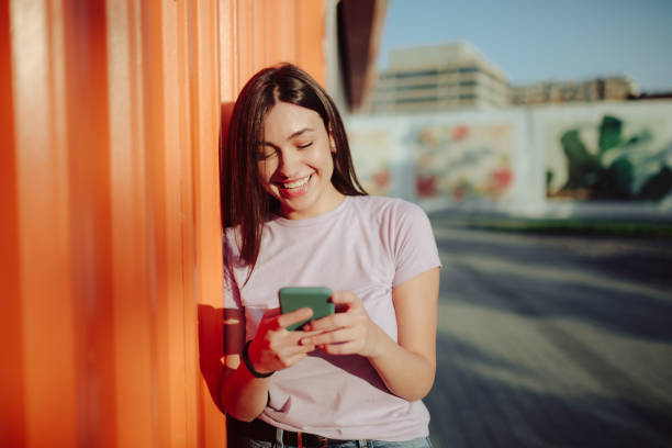 istock Happy young Caucasian woman using a smart phone 1285316472