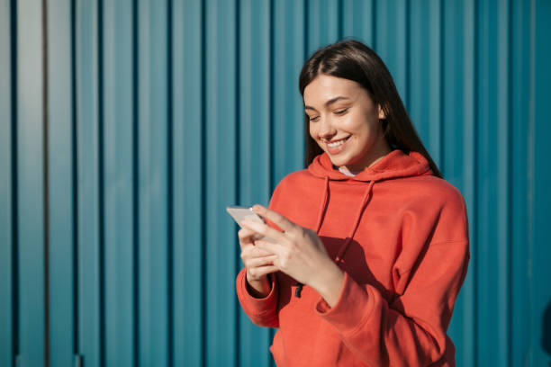 istock Happy young Caucasian woman using a smart phone 1285316493