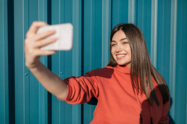istock Happy young Caucasian woman using a smart phone 1285316536