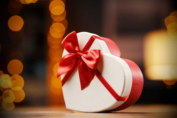 istock Heart shaped Christmas present and decorative lights 1285318575