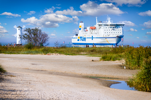 Swinoujscie, Poland - September 23, 2020: Baltic Sea ferry Nils Dacke slowly is entering the Swinoujscie harbor. Unity Line is a German shipping company that operates RoRo and train ferry services between Świnoujście in Poland and the Swedish ports of Trelleborg