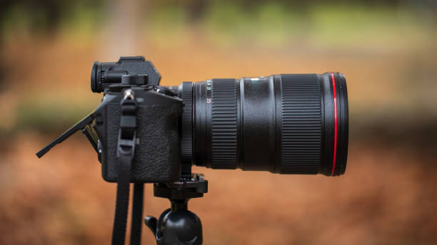 istock Camera on a tripod with a blurred background in the fall stock photo 1285320264