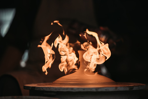 close up of blow torch fire burning pottery