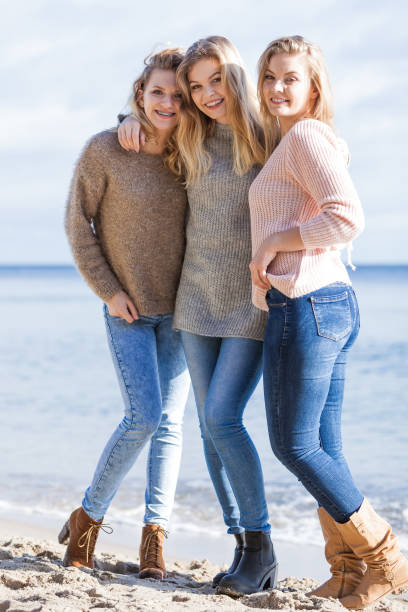istock Three fashionable sister on the beach 1285324252
