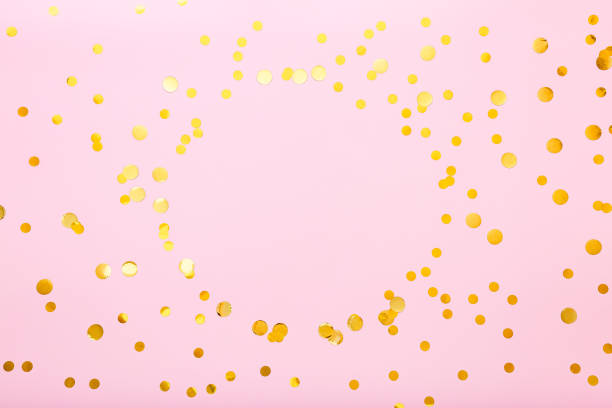 istock Gold confetti sparkles frame on pink background. Flat lay, top view festive backdrop with circle copy space. Celebration concept. 1285324394