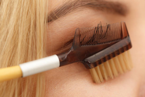 istock Woman brushing her eyelashes 1285325299