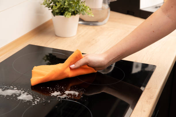 istock Woman cleaning induction stove 1285325629
