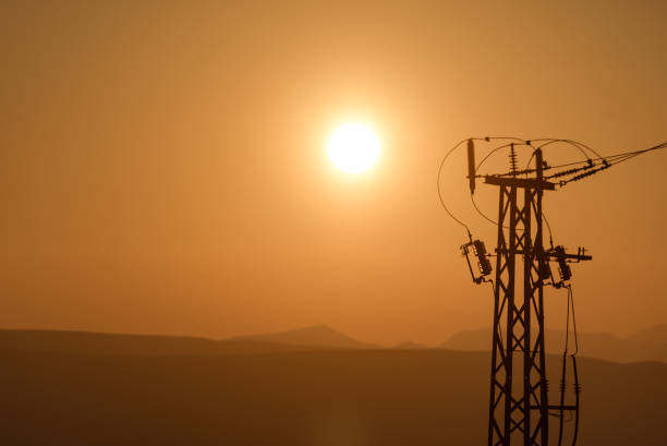 istock High voltage towers on coast at sunset 1285326861