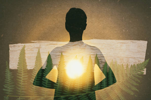 Female silhouette radiating light from within a spiritual heart opening