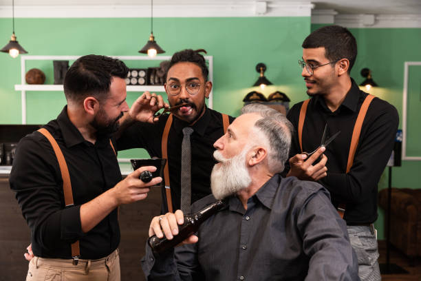 istock Multi-ethnic barbers joke with a customer with a beer in hand. 1285327988