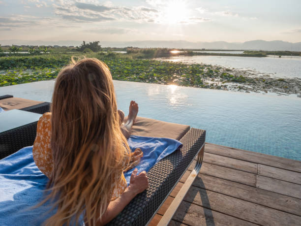 istock Woman relaxing by the poolside 1285328322