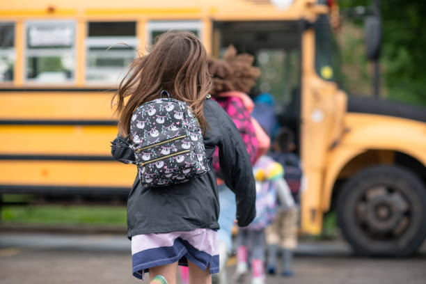 istock Kids getting onto the school bus 1285329421