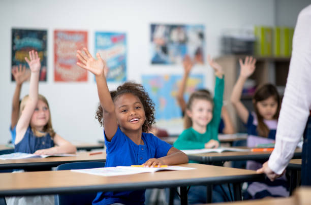 istock Girl raising hand in class 1285329427