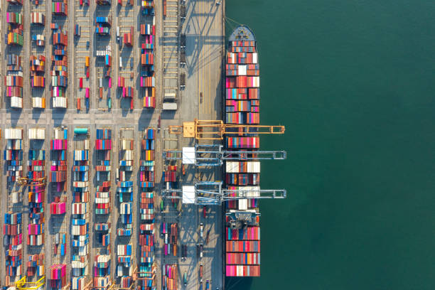 istock Container , container ship in export and import business and logistics. Shipping cargo to harbor by crane. Water transport International. Aerial view and top view. 1285330181