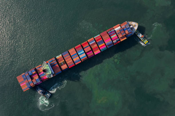 istock Container , container ship in export and import business and logistics. Shipping cargo to harbor by crane. Water transport International. Aerial view and top view. 1285330234