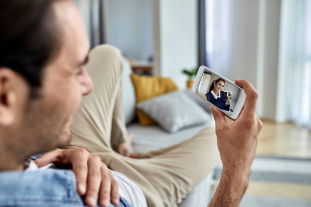 istock Close-up of man using smart phone at home. 1285332759
