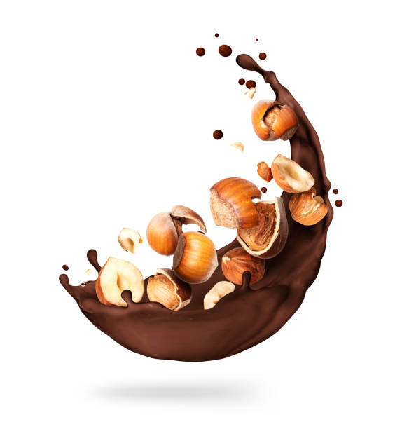 istock Chocolate splashes with crushed hazelnuts close-up on a white background 1285332799