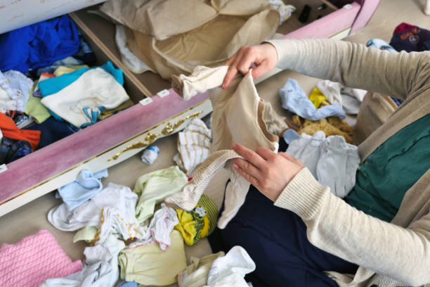 istock a woman folds clean clothes, fold clothes, 1285333524