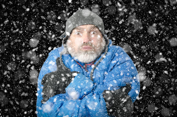 istock Portrait of man freezing under snowfall 1285334633