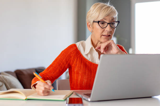 istock Senior woman watching online course on the laptop 1285335516