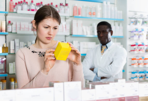 istock Pensive young woman choosing medicines in modern pharmacy 1285335554