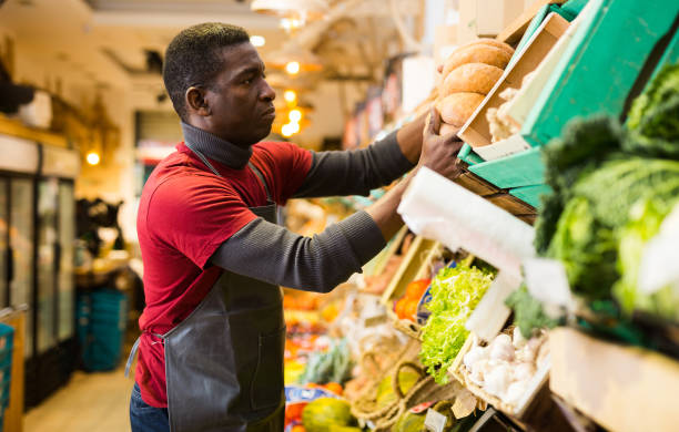 istock Seller arranging squash on greengrocery counter 1285335824