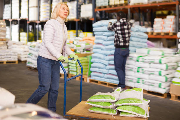 istock Positive mature workwoman carrying trolley 1285335923