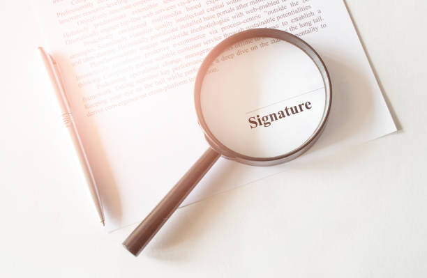istock Signaure line in contract with pen and magnifying glass 1285336646