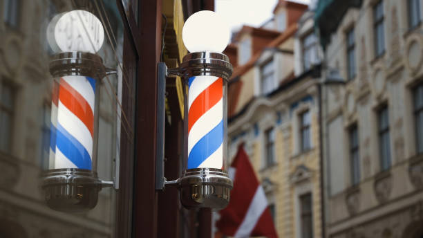 istock Bright barbershop pole spinning and reflecting in mirror 1285337727