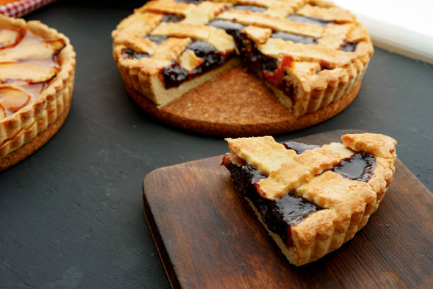 istock Cut slice of berry tart pie on black table 1285338376