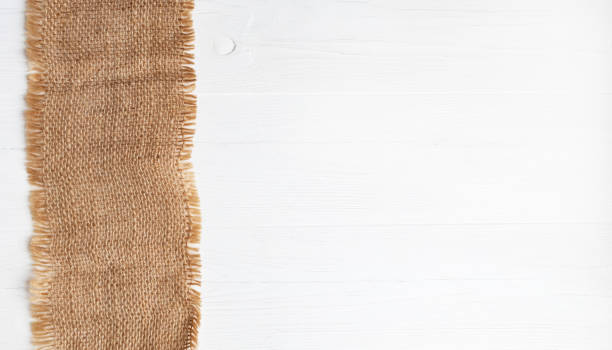 rough linen napkin on a white wooden background with space for text. layout. - gunny sack imagens e fotografias de stock