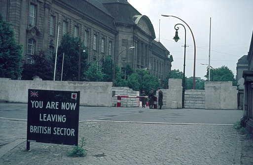 Berlin (West), Germany, 1962. Invalidenstrasse border crossing into the Soviet occupied sector in Berlin. Also: three East German border guards, a notice board from the Western Allies and in the background the Natural History Museum.