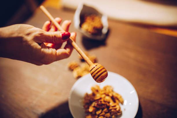 istock Walnuts and homey   on old wood background 1285339820