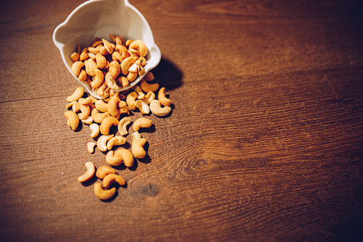 Cashew nuts on wooden brown table
